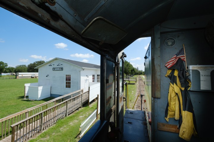 a person standing next to a train station